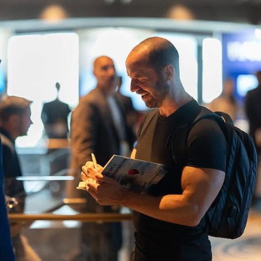 Todd Kashdan signing a copy of The Art of Insubordination