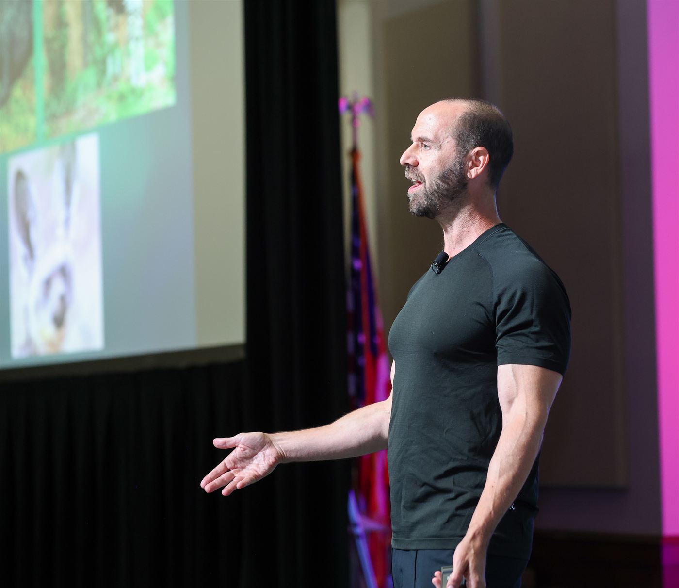 Todd Kashdan mid-talk, gesturing toward a slide